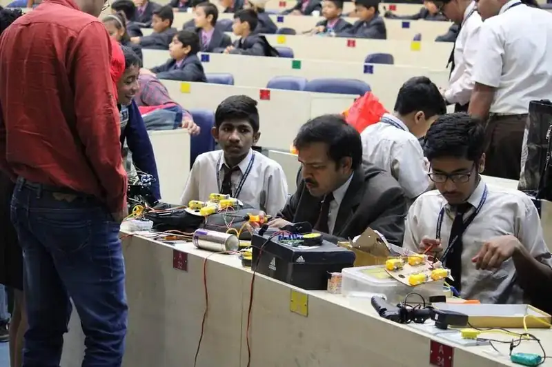 Students demonstrating their project to a judge
